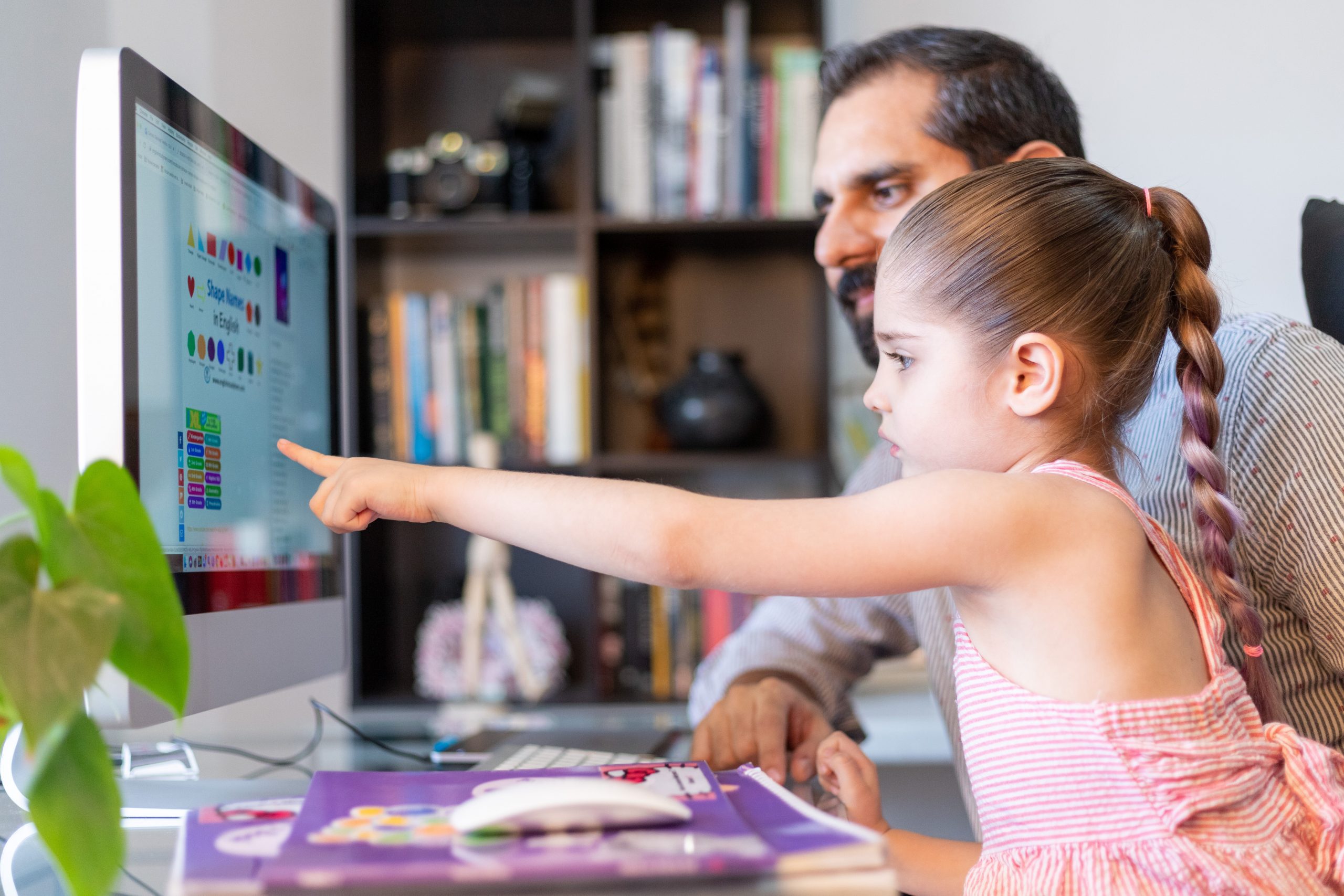 parent teaching from home with computer